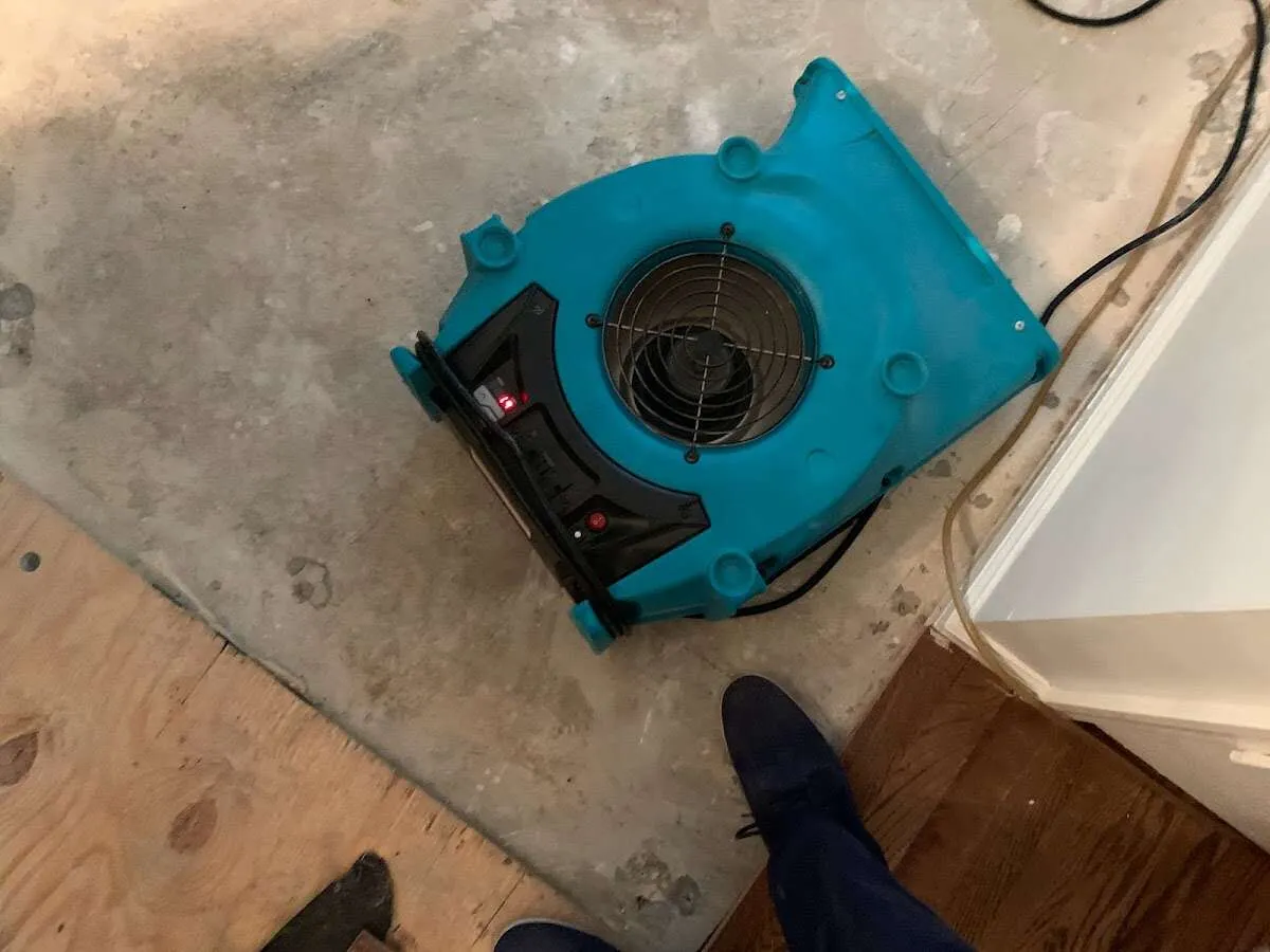 Air mover drying subfloor during Leak Detection & Repair in Media